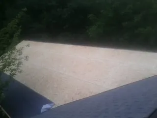 New OSB roof sheathing installed beside an existing shingle roof in Granite Springs