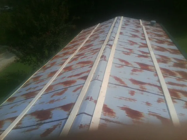 Rusted metal roof panels with new wood purlins before replacement — Storm Damage Roof Repair in Granite Springs by Roofing Brothers